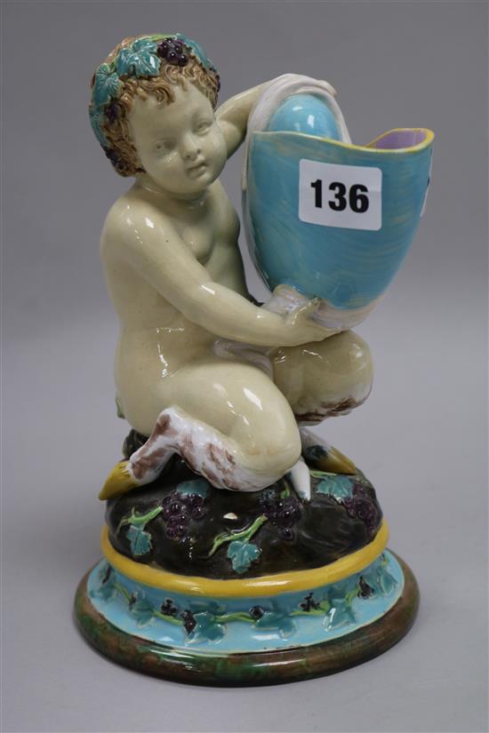 A Victorian majolica model of a faun holding a nautilus shell height 22cm